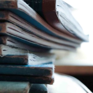 Image of a pile of exercise books for the Progress monitoring and intervention; School reports and parents evenings post